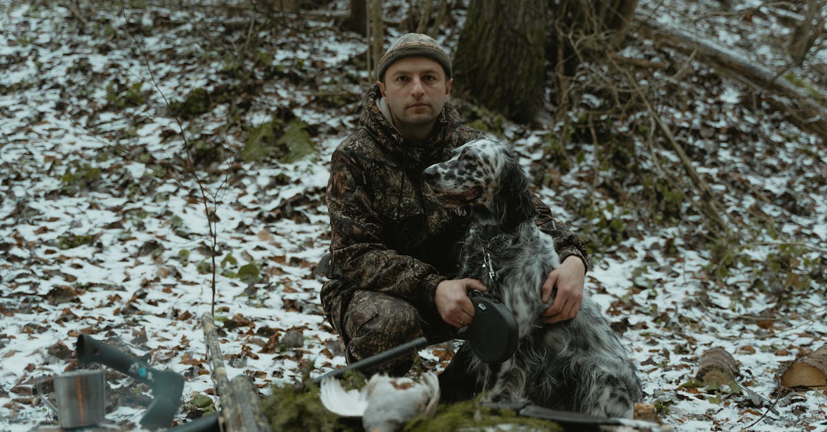 Hunter looking through rifle scope in the woods