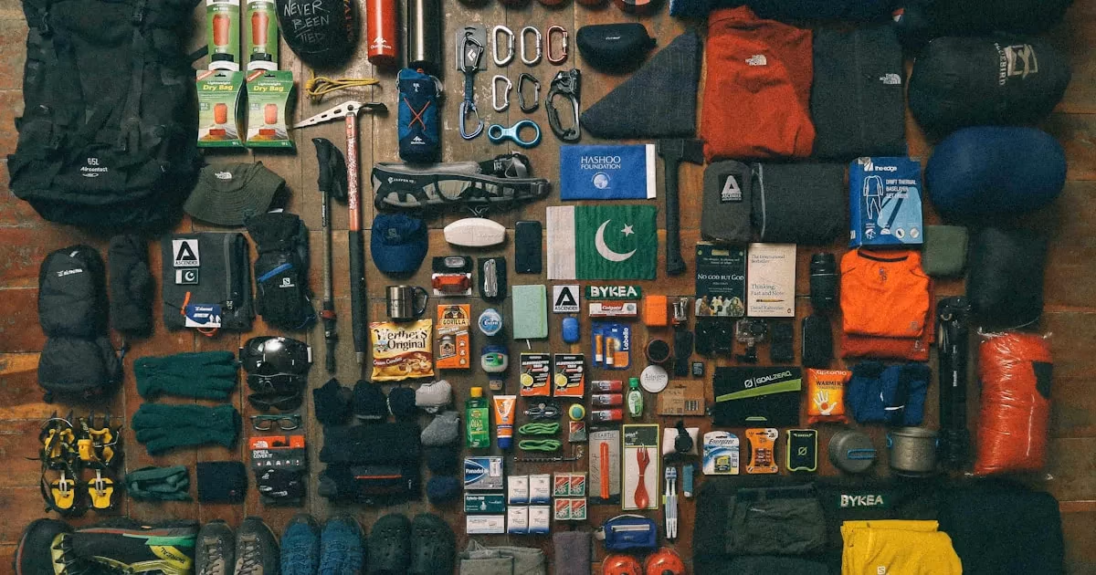Emergency supplies organized on a table including water, flashlights, and first aid kit