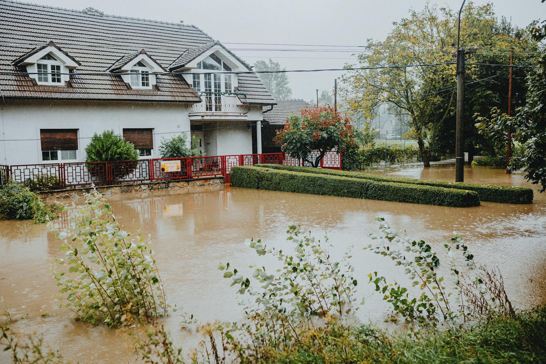 Emergency preparedness supplies next to a local flood zone map showing risk areas