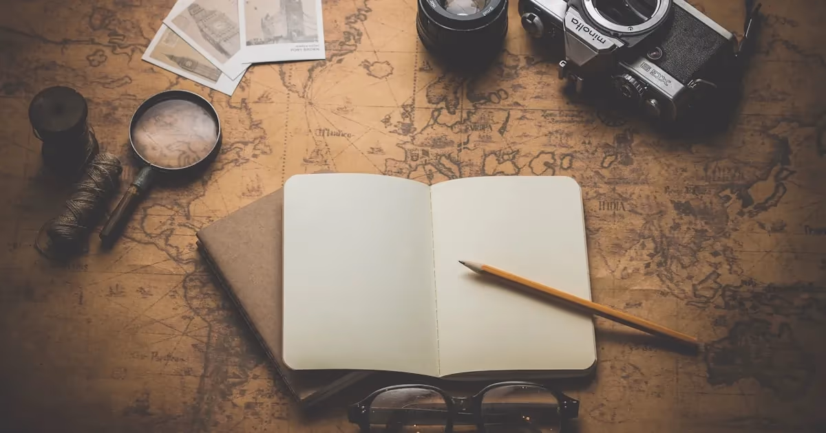 A topographic map spread on a rock with a compass and pencil beside it