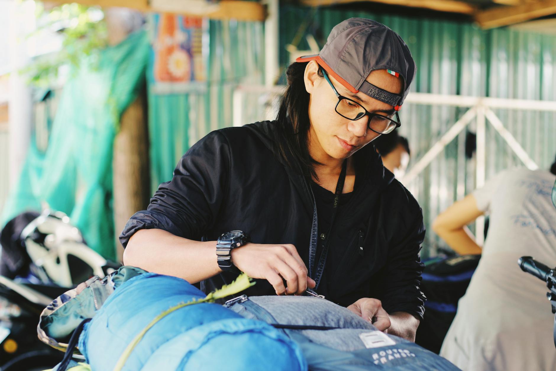 Backpacker weighing gear items on a digital scale before a wilderness trip