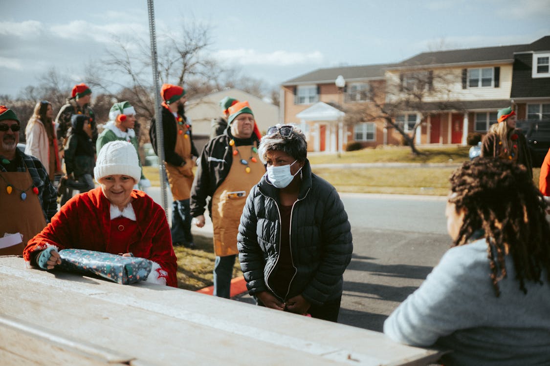 Neighbors gathered outside homes discussing emergency plans in a residential neighborhood