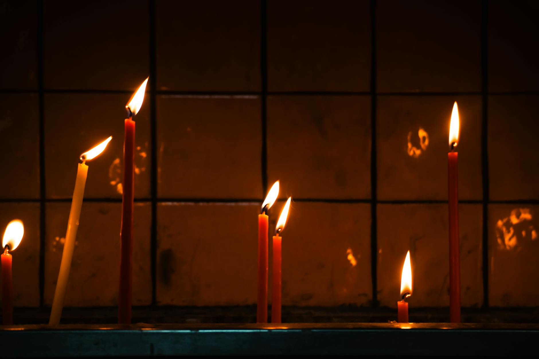 Dark house interior with candles during power outage, showing inadequate emergency lighting