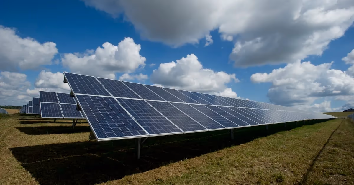 Solar panels mounted on the roof of an off-grid cabin with battery bank visible inside