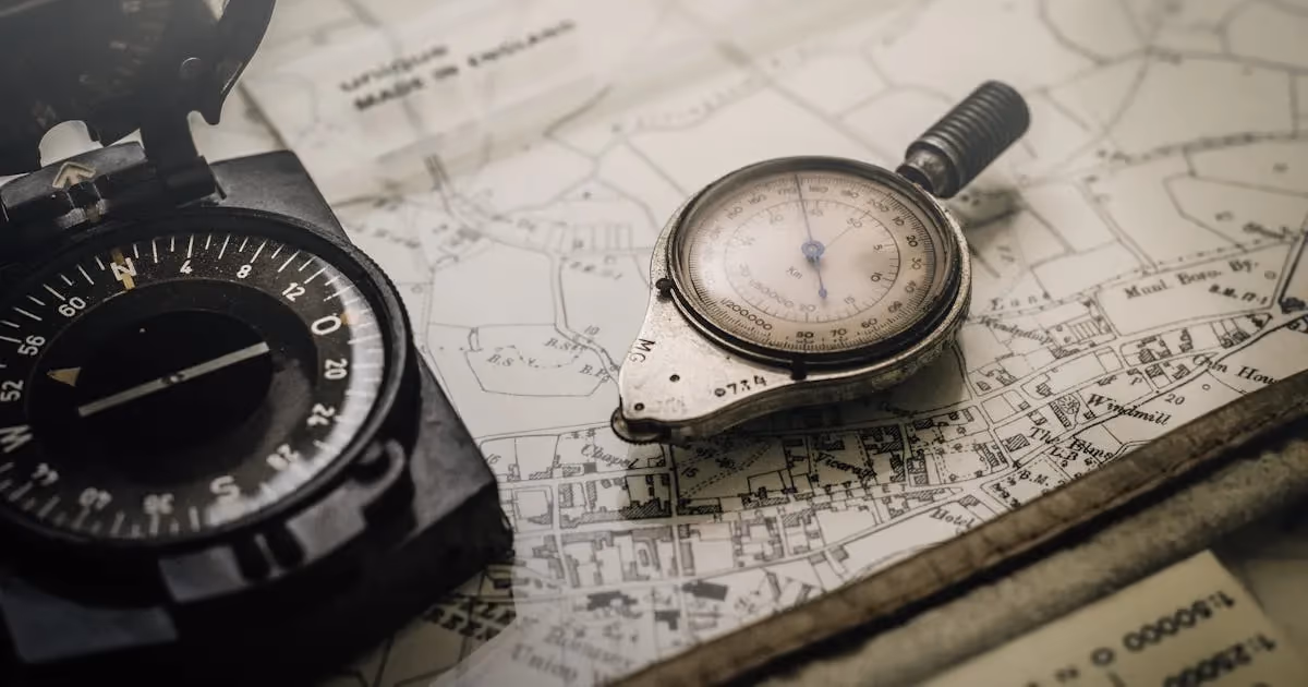 A hiker using a compass and map for wilderness navigation on a forest trail